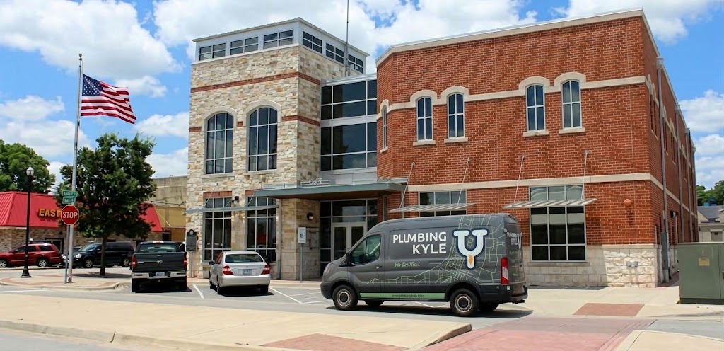 Plumbing Kyle service van parked outside a local commercial building